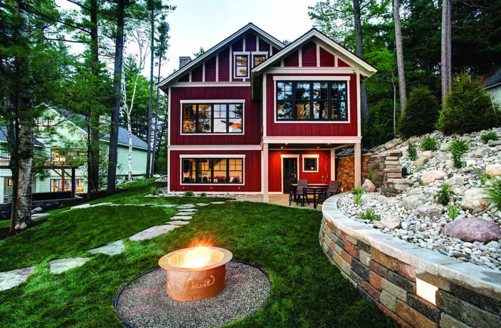exterior Lakemore Lodge with active firepit and landscaped grounds